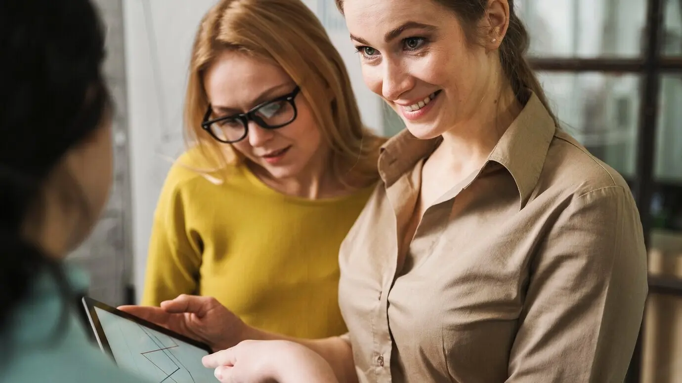 Smiling businesswomen during a meeting with a tablet