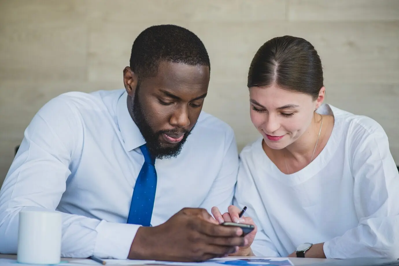 Two businesspeople with a smartphone