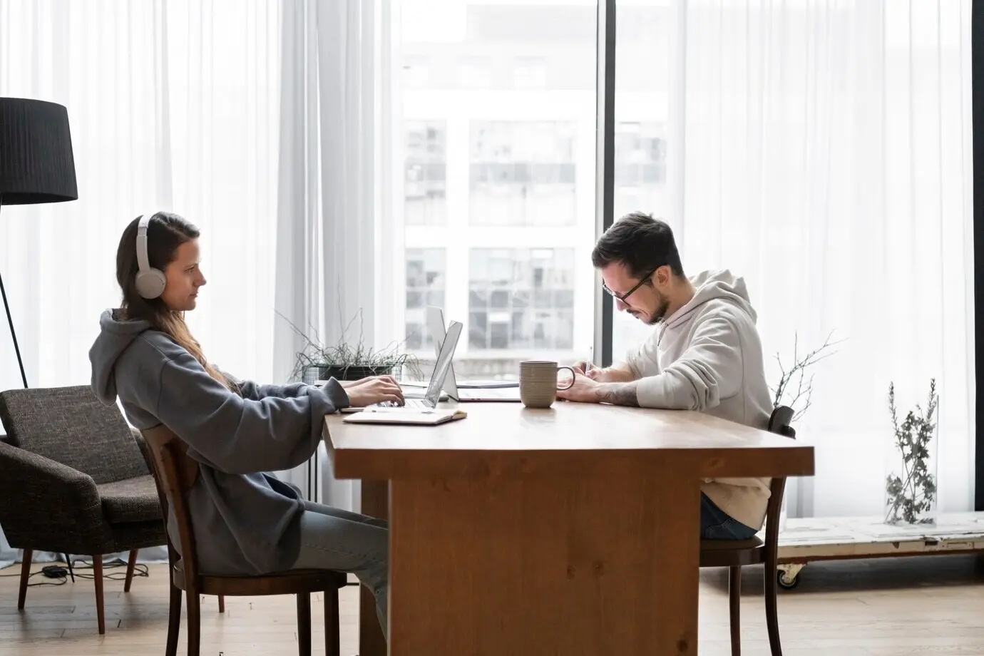 A man and a woman working from home together at a desk