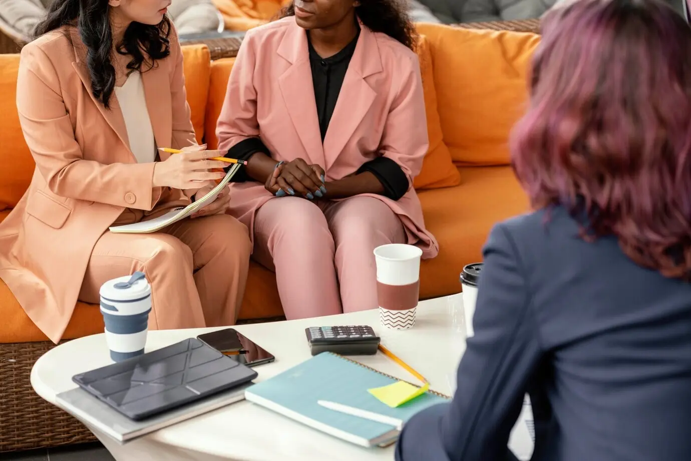 Close-up view of women discussing work